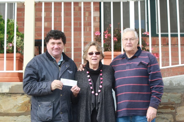 Princess Royal Station's Simon Rowe hands over the cheque to Meals on Wheels Burra chair Bev Fleming and treasurer Peter Ferris.